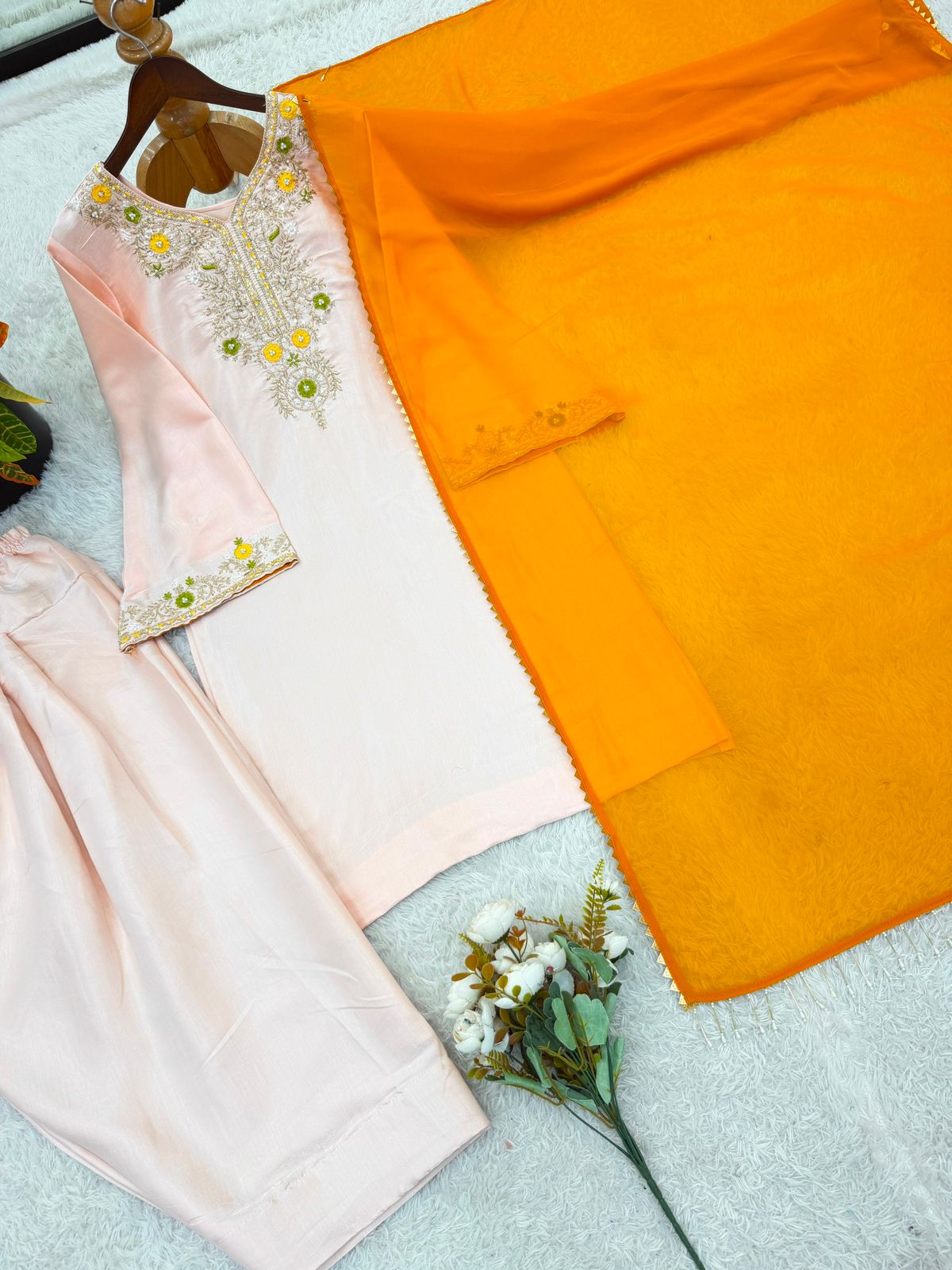 Model wearing peach salwar suit with mustard dupatta