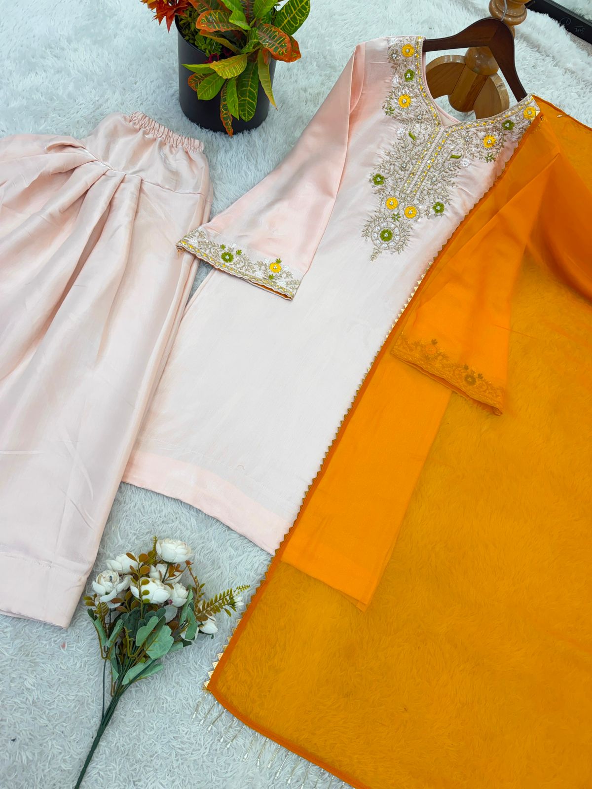 Model smiling in peach embroidered salwar suit