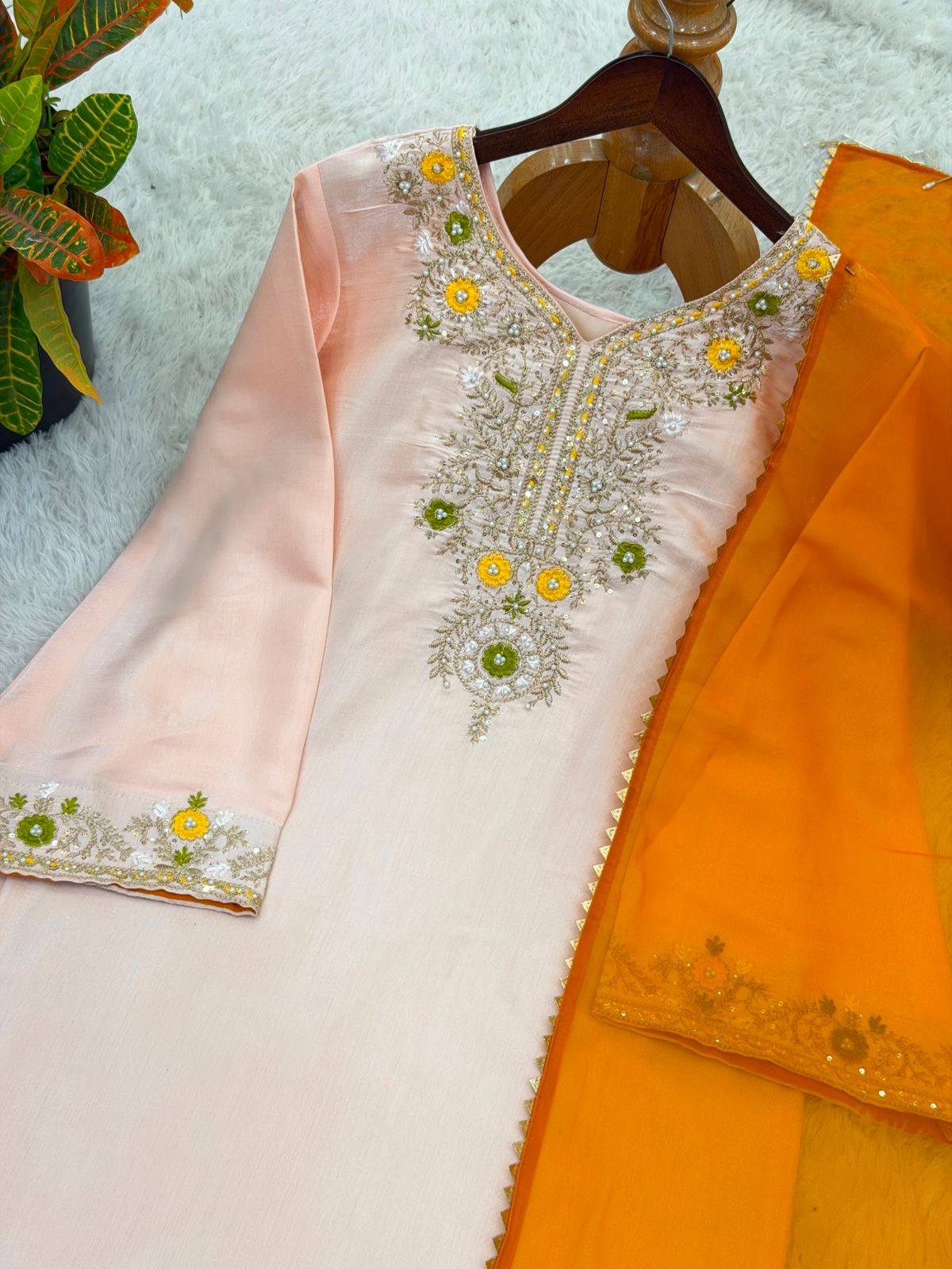 Model posing in peach ethnic wear set