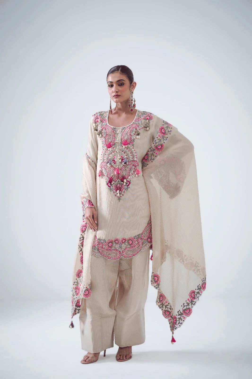 Flat lay of cream embroidered kurti with farshi pent and dupatta