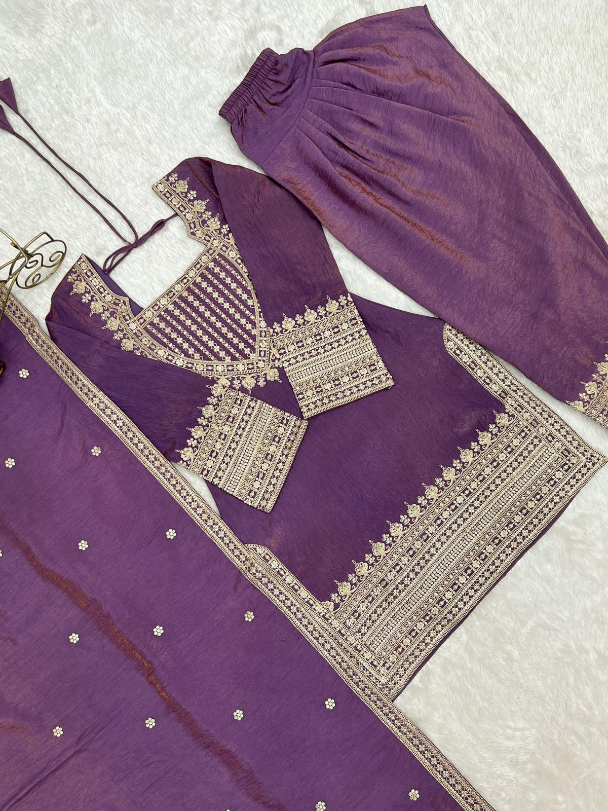 Flat lay of sea green vichitra silk suit with dupatta and farshi shalwar