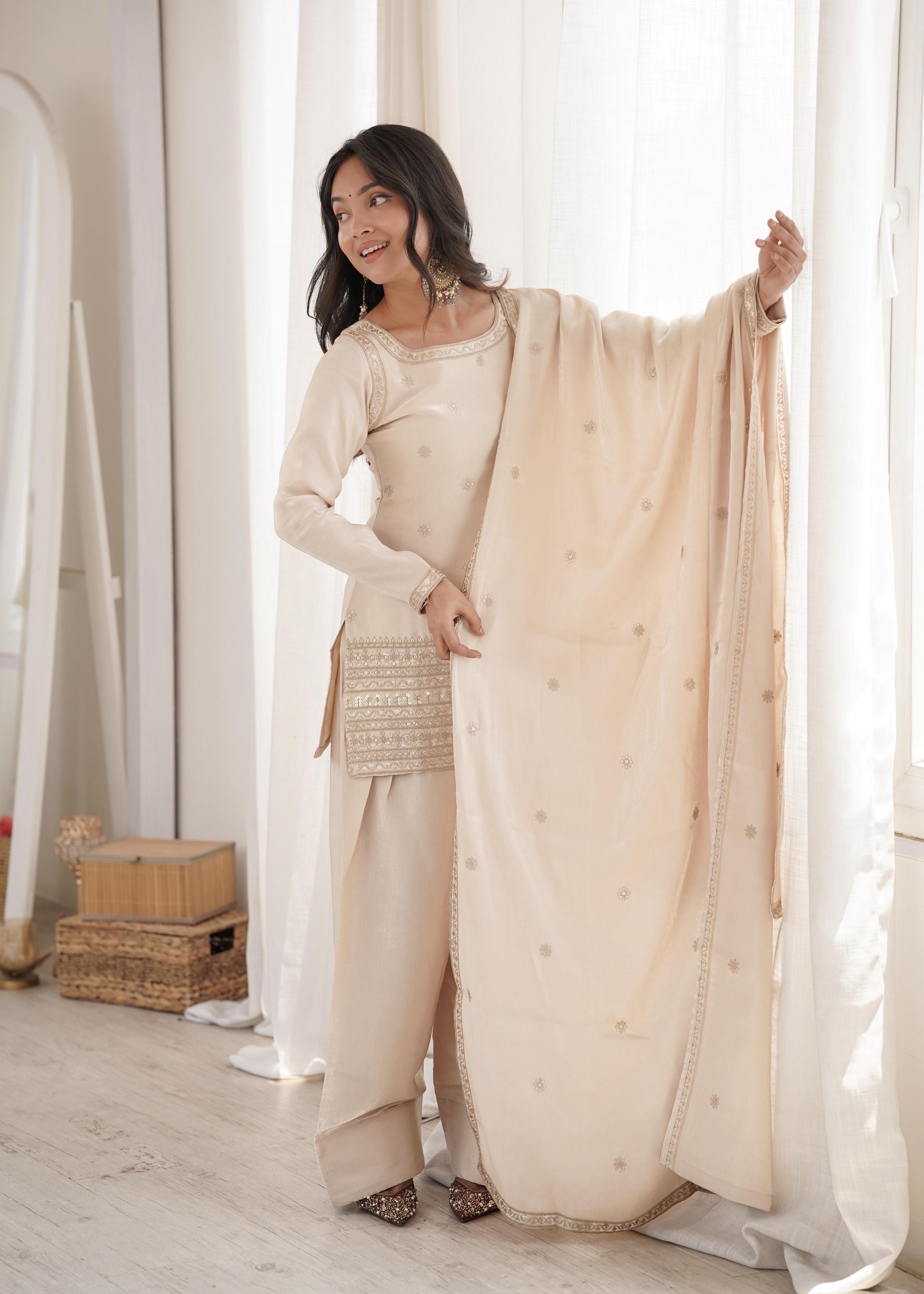 Model in cream glass roman silk sequin embroidered suit set holding dupatta