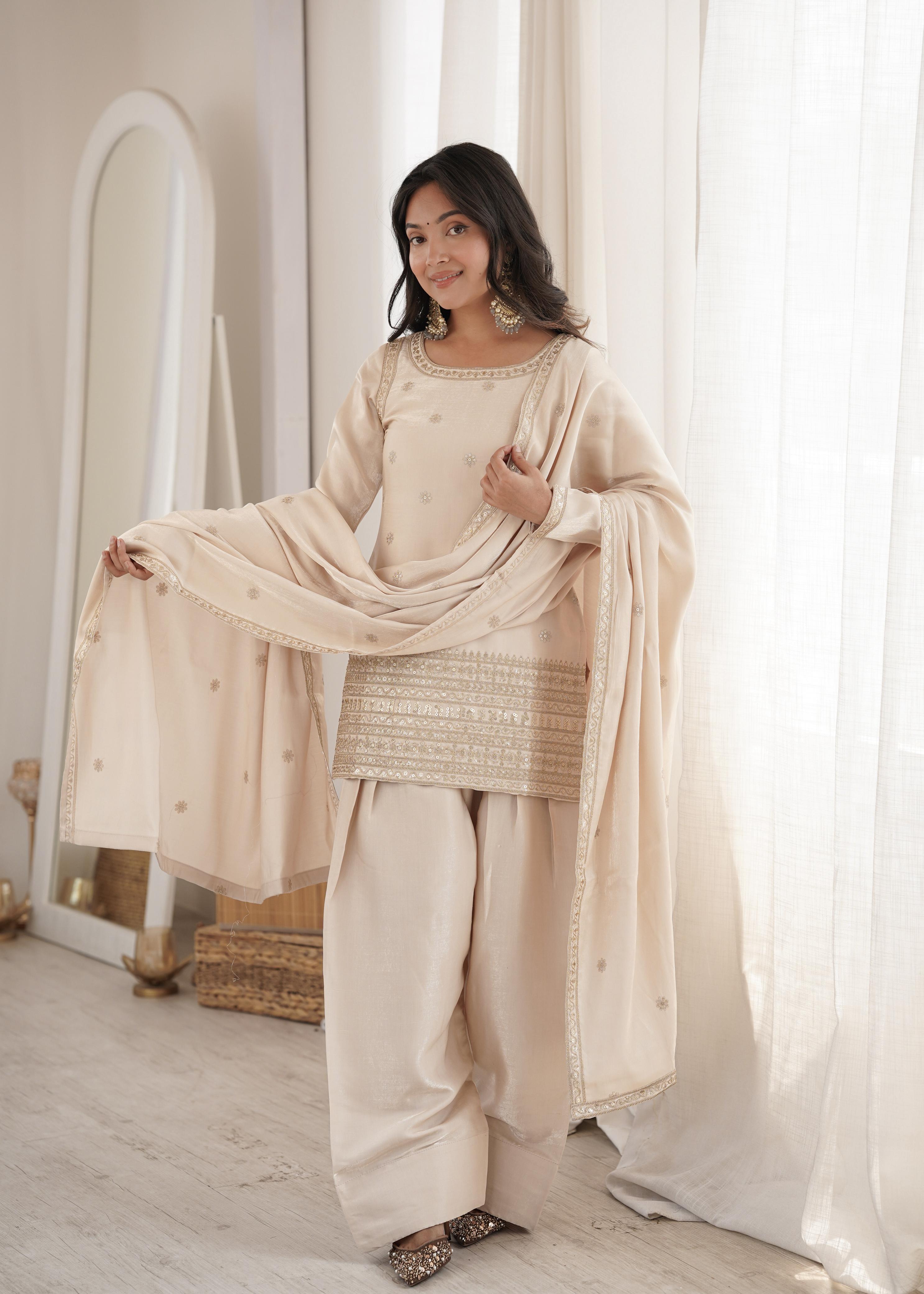 Flat lay of cream glass roman silk kurta showing sequin yoke and floral motifs