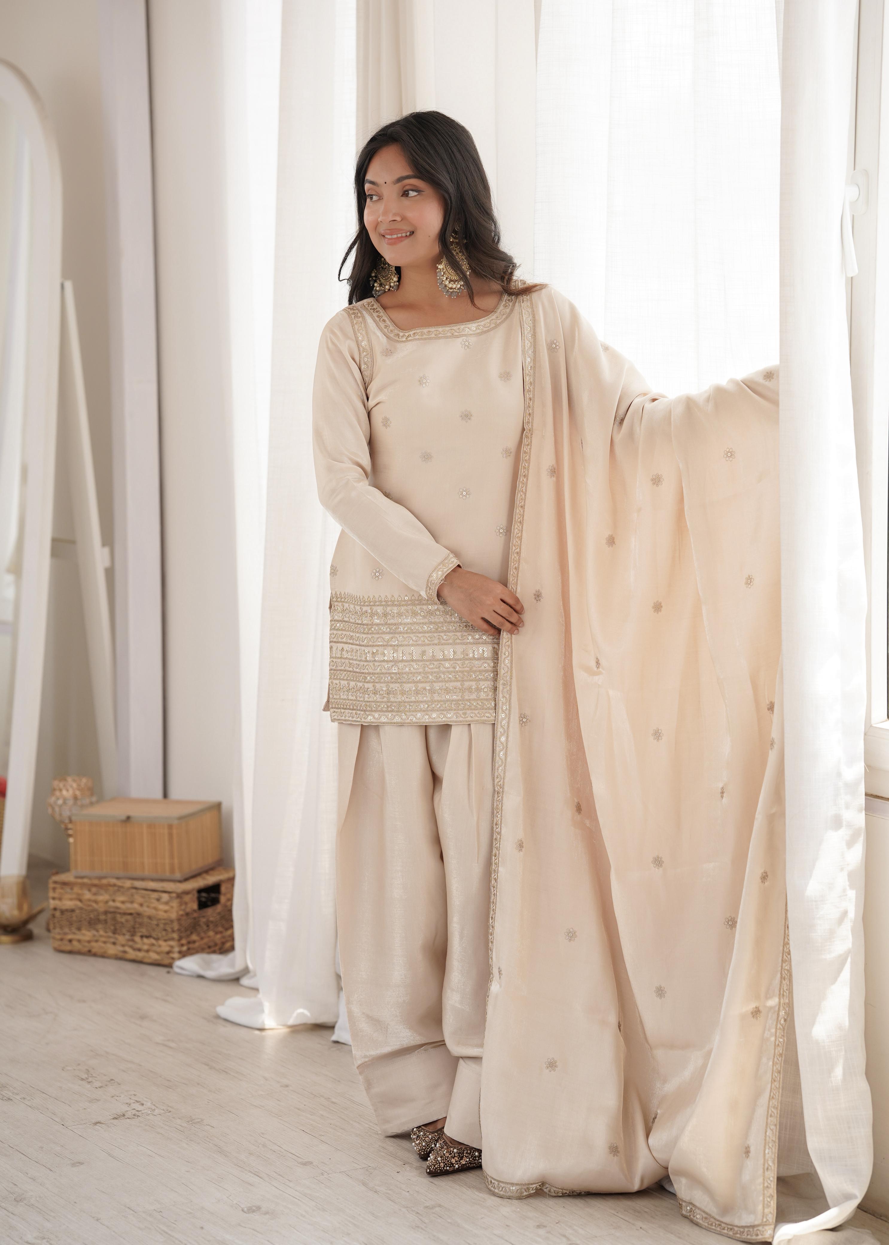 Flat lay close-up of cream kurta with gold sequin jari yoke work