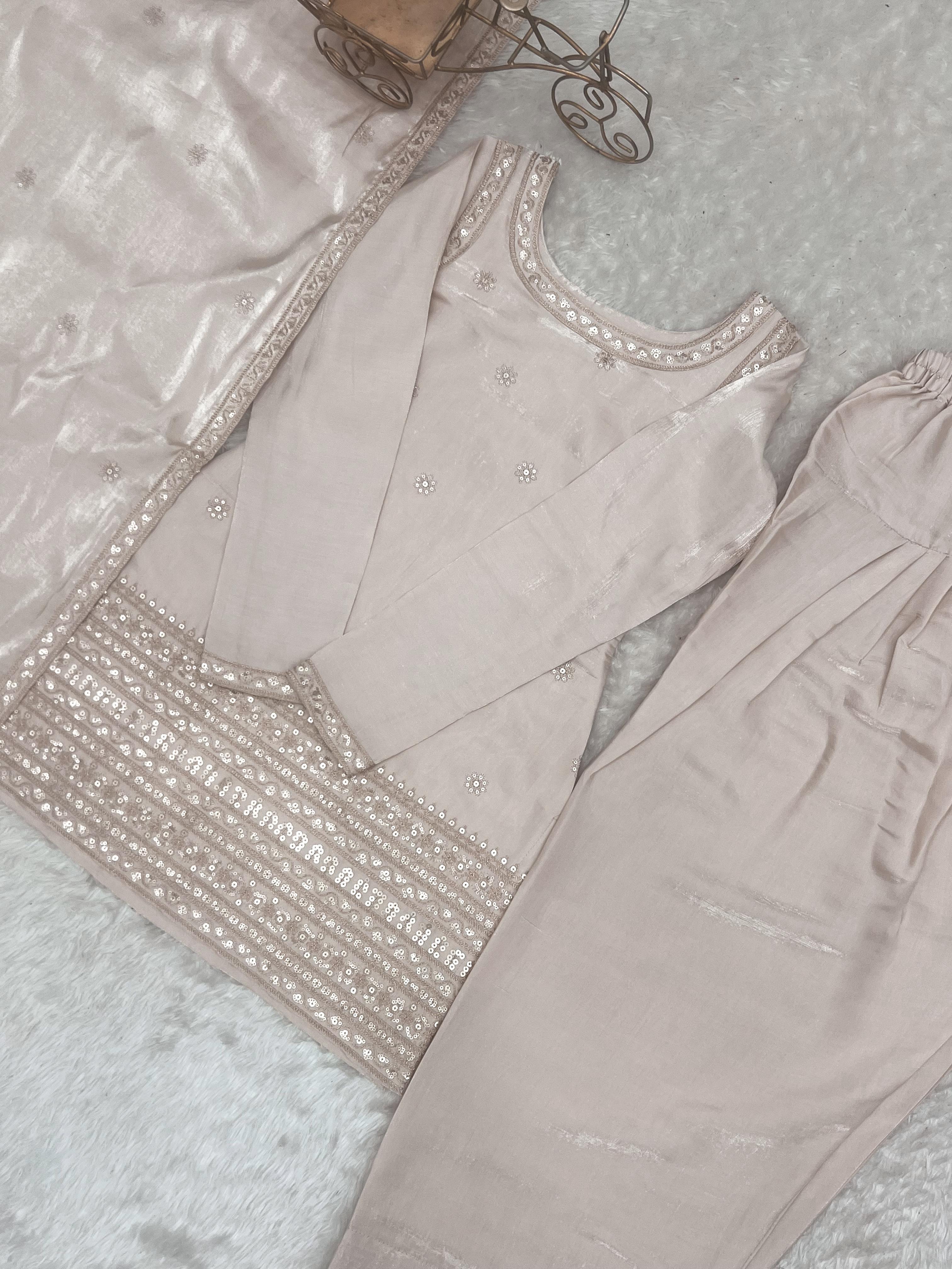 Flat lay of cream suit set showing front yoke sequin detail and farshi shalwar