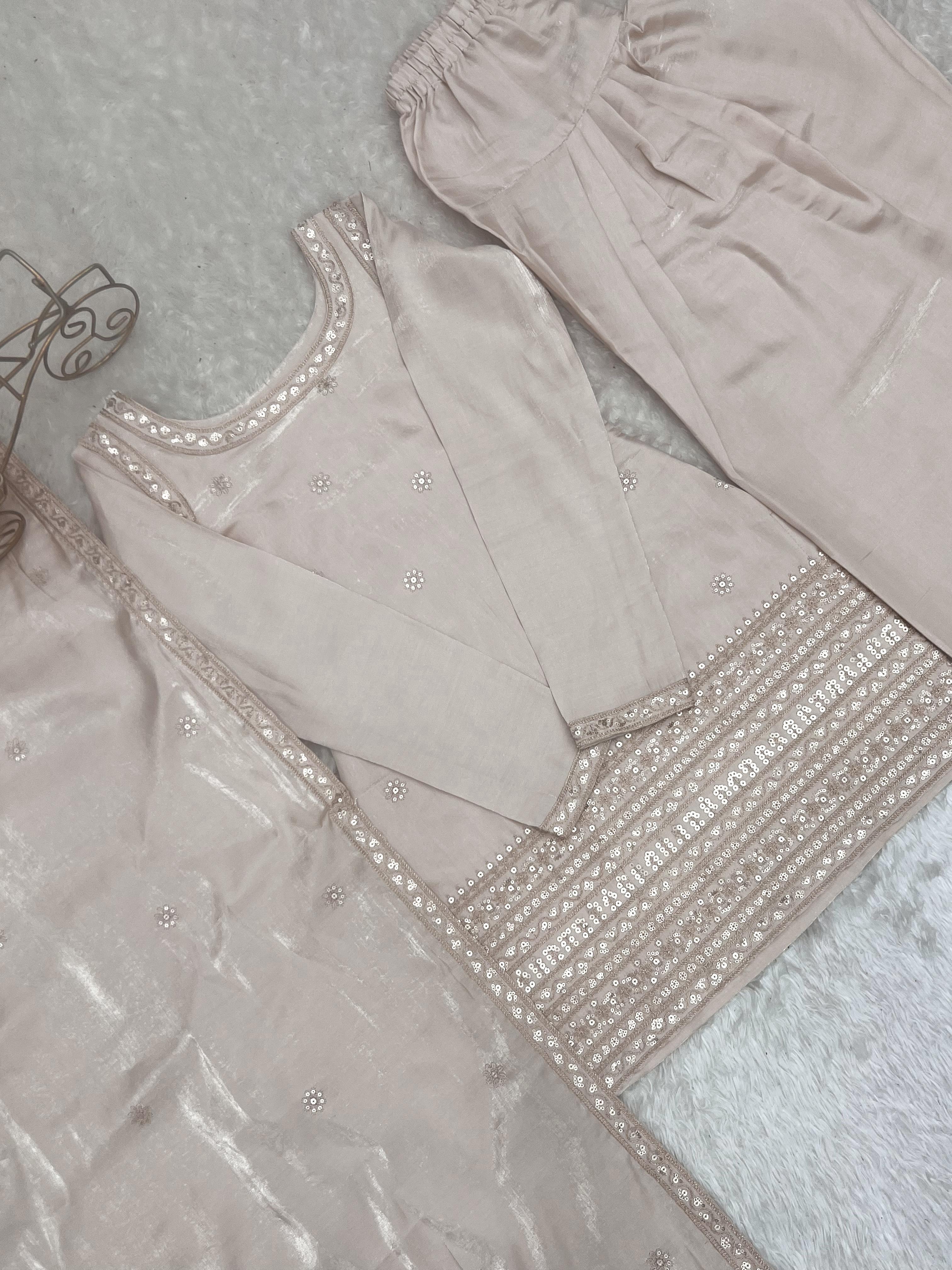 Flat lay of cream suit set with dupatta showing sequin border lace work