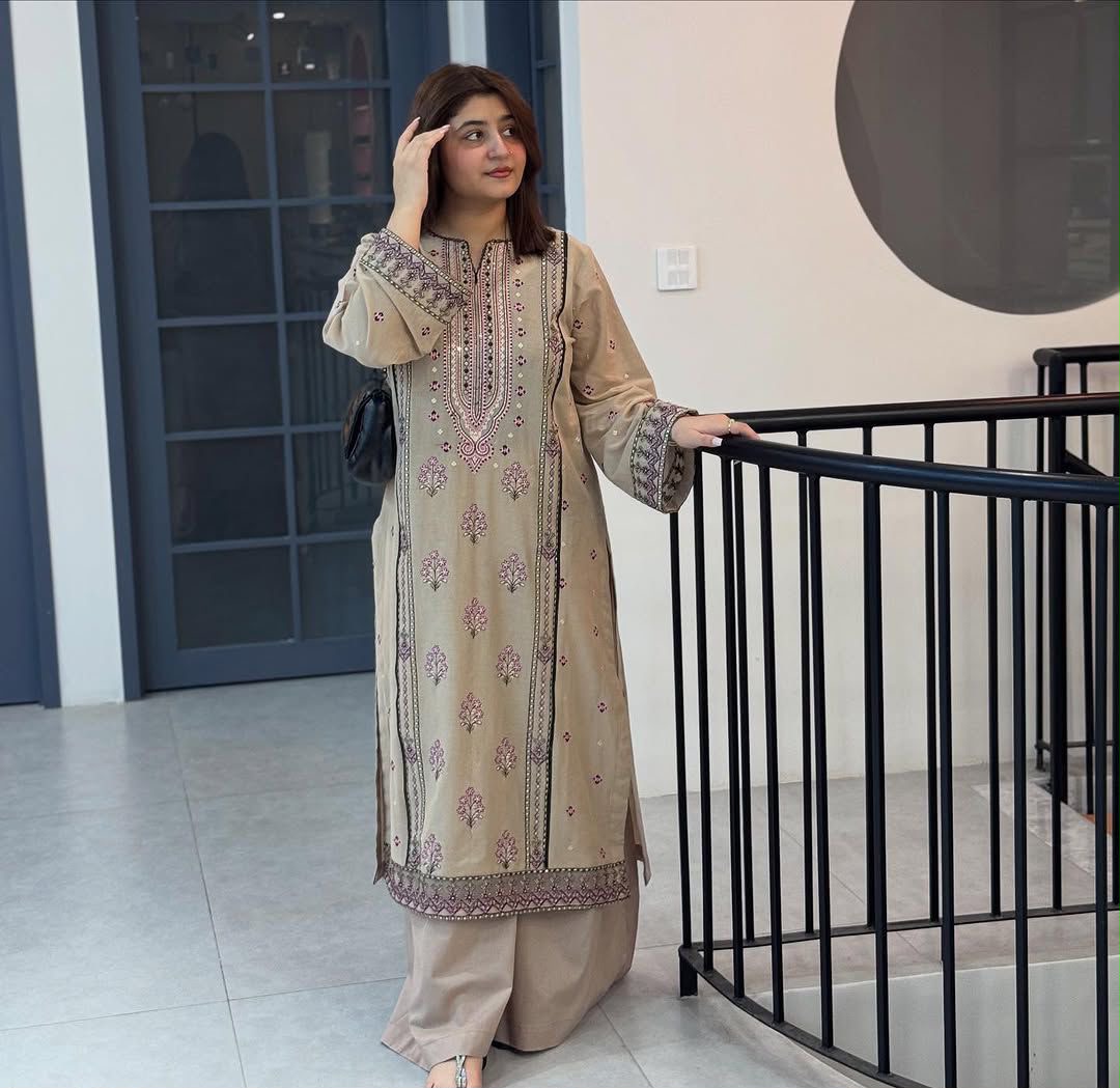 Flat lay of beige faux georgette suit set showing full yoke embroidery detail