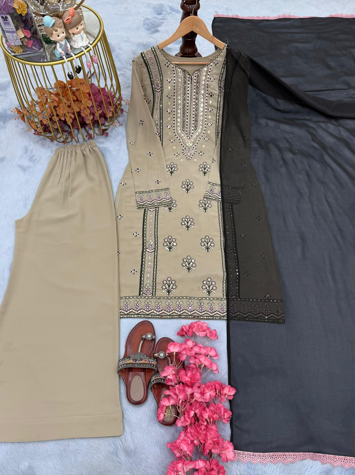 Flat lay of complete beige 3-piece suit set with charcoal dupatta and palazzo