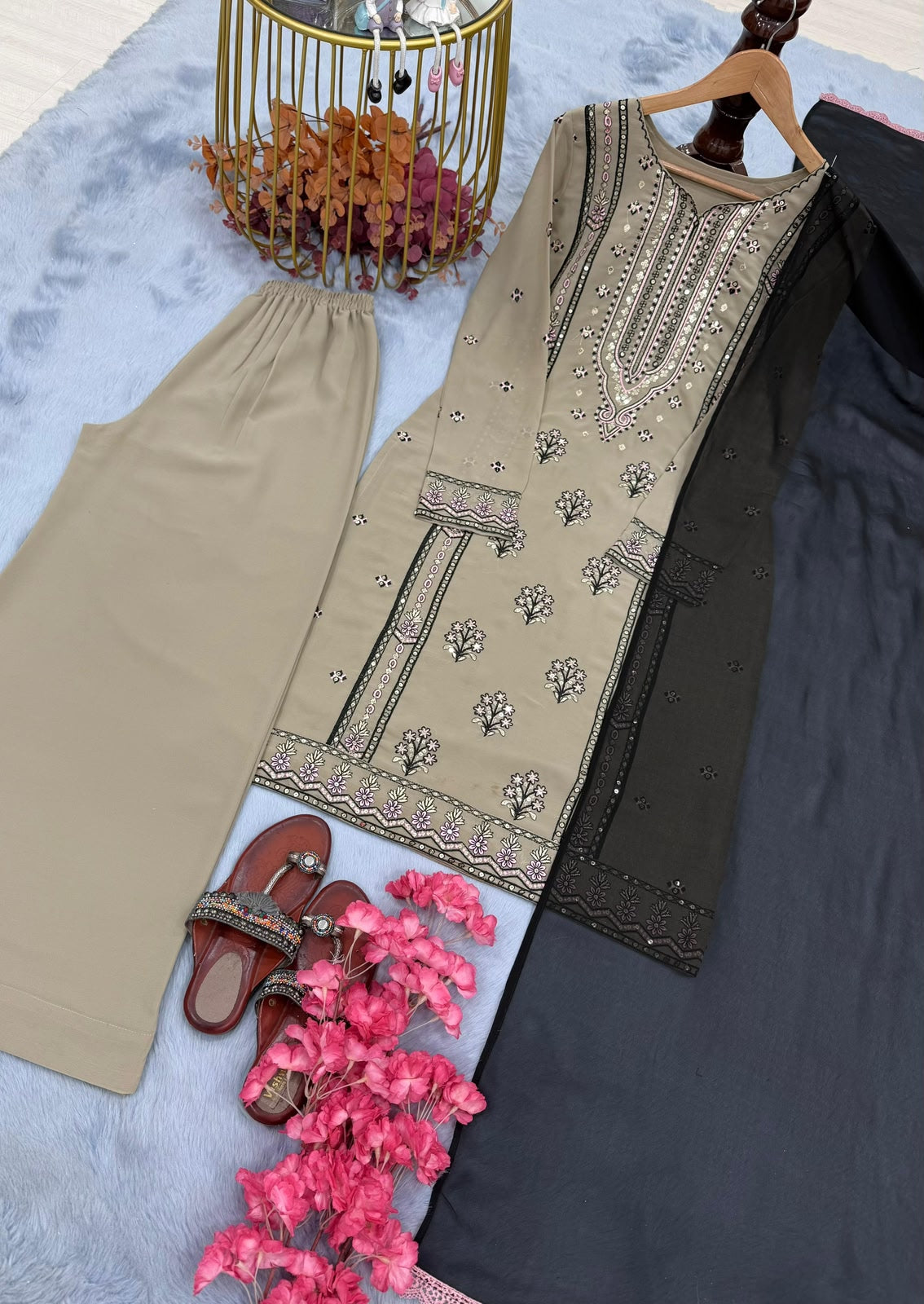 Flat lay close-up of beige kurta showing sequence yoke and sleeve embroidery