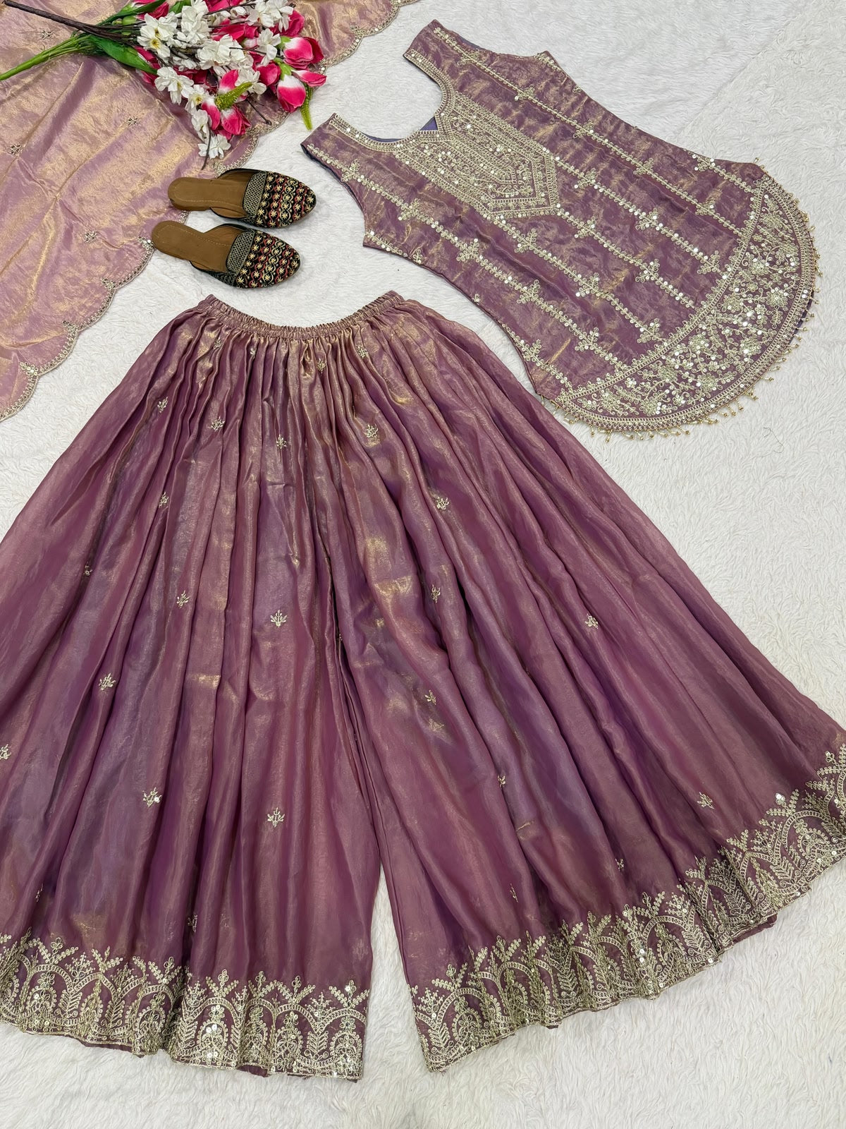 Flat lay close-up of mauve embroidered kurta showing sequin yoke and tassel hem