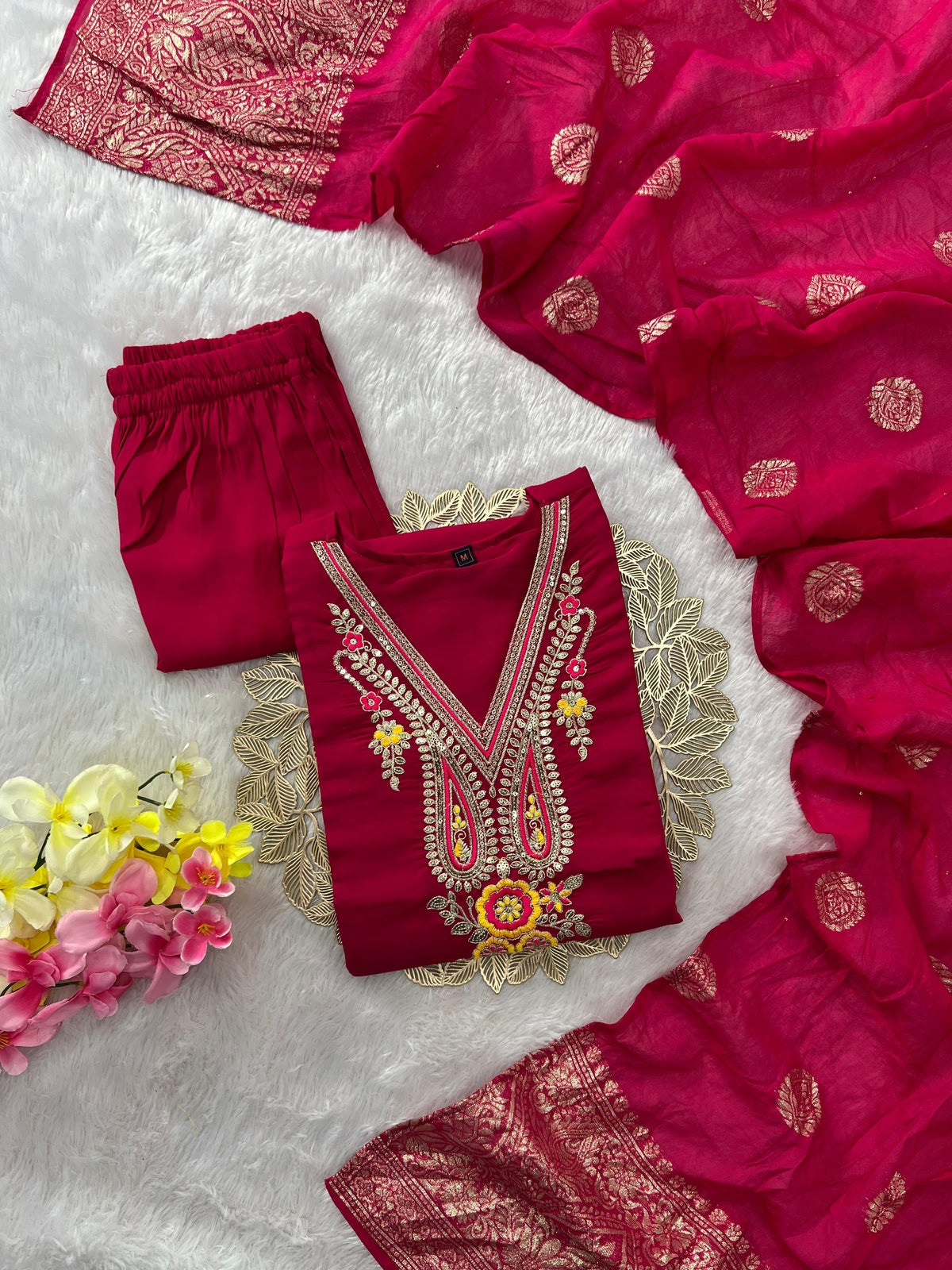 Flat lay of complete rani pink 3-piece suit set with zari dupatta and straight pant