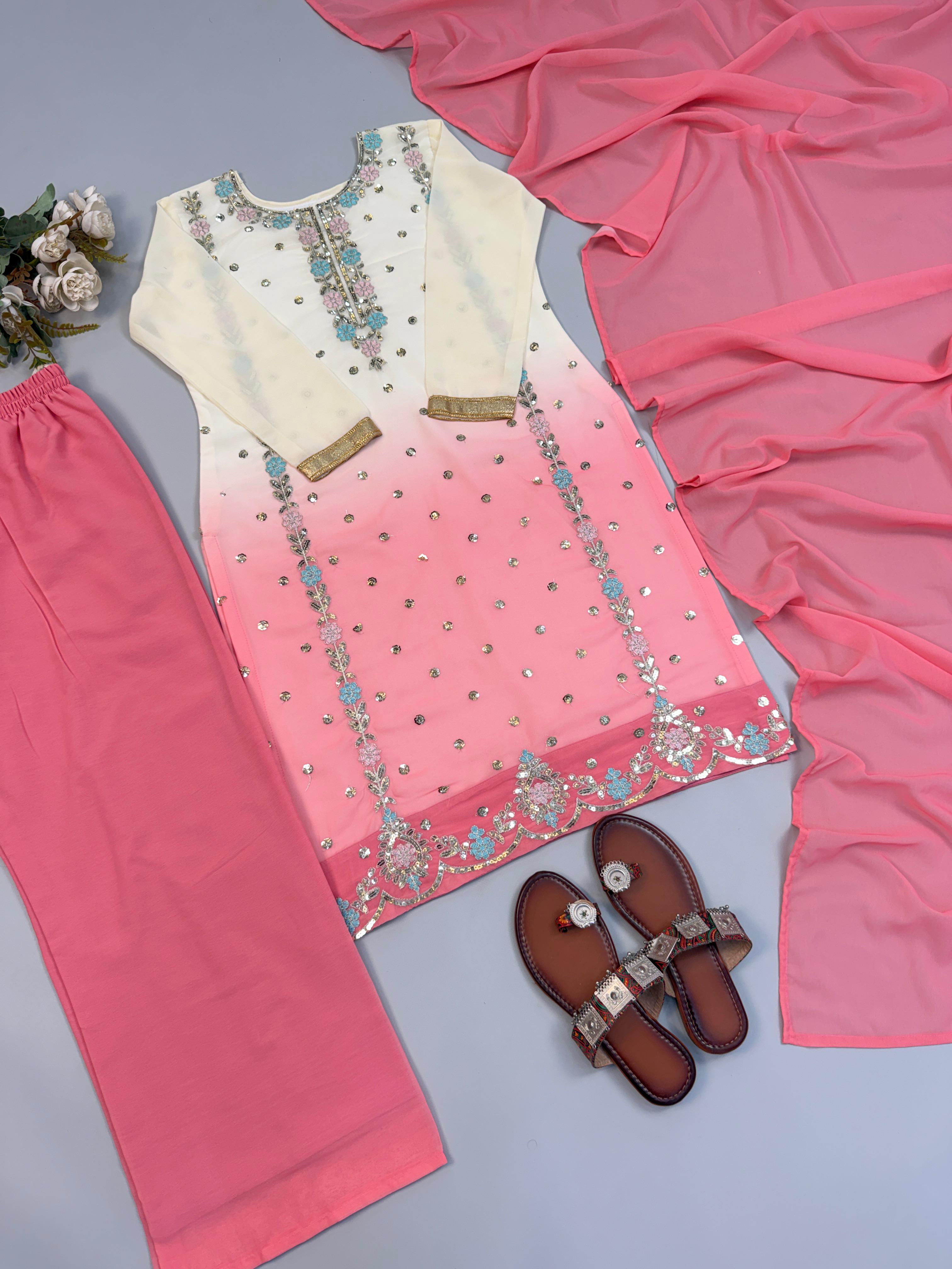 Flat lay of orange ombre faux georgette embroidery sequence suit set with dupatta and pant