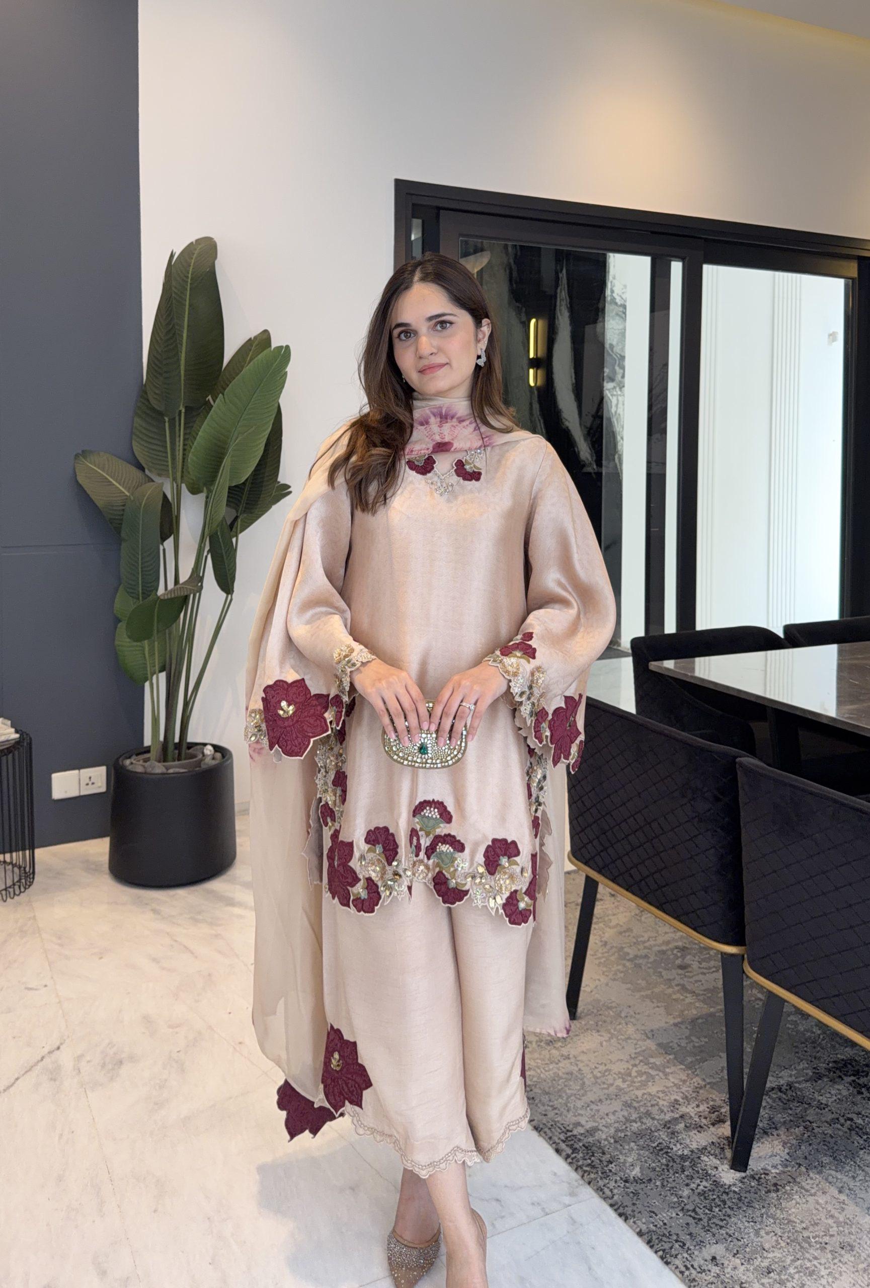 Model wearing black roman glass embroidery suit set full length view in luxury interior