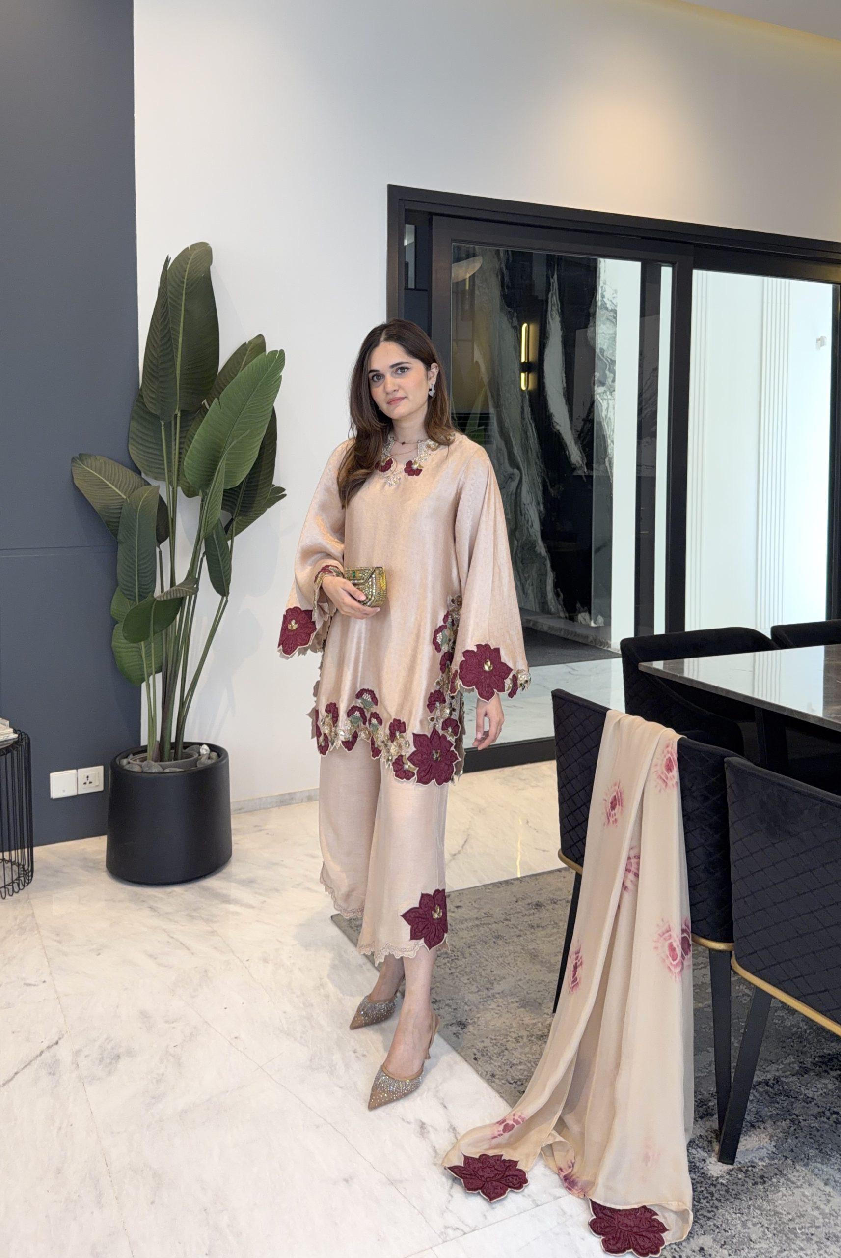 Model wearing black roman glass embroidery kurta pant set showing floral hem border detail