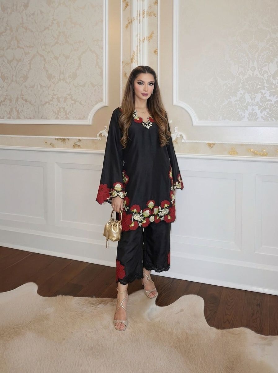 Flat lay of black roman glass suit set with pant and printed fox georgette dupatta