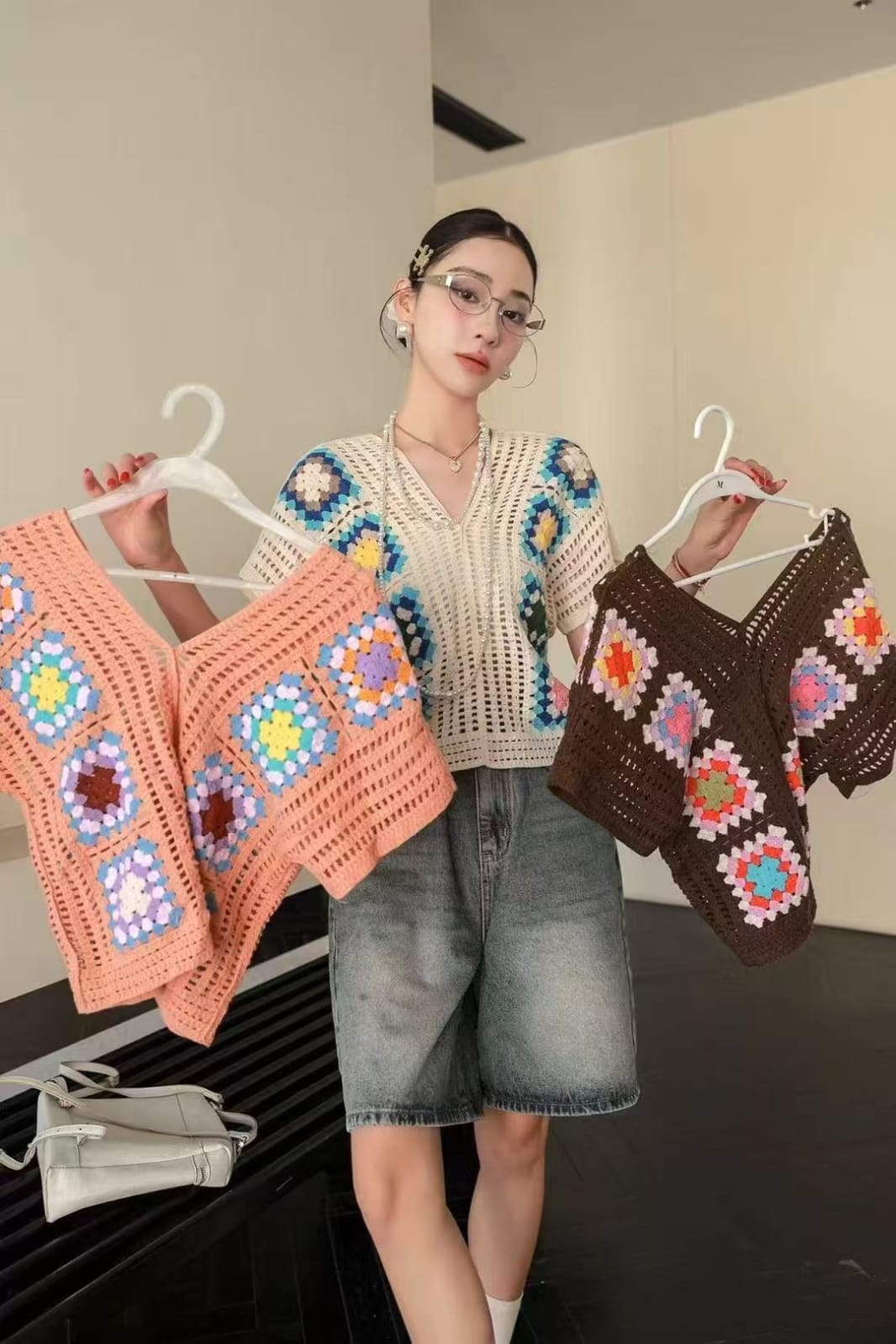 Beautiful Crochet Top - cream granny square V-neck model holding peach and brown variants